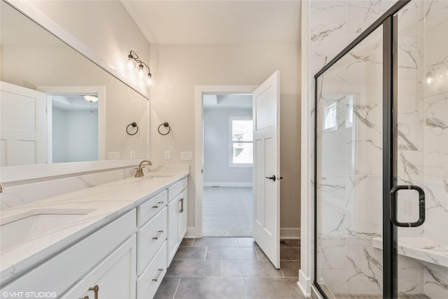 bathroom with an enclosed shower, vanity, and tile patterned flooring