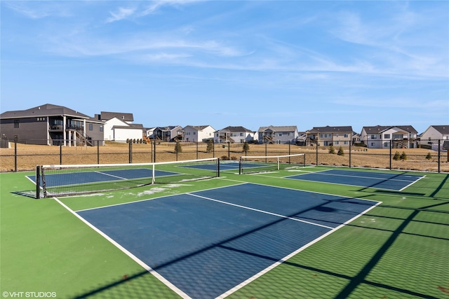 view of tennis court with basketball hoop