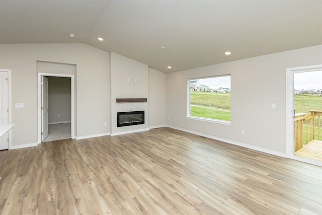 unfurnished living room featuring light hardwood / wood-style floors and lofted ceiling