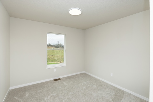 empty room featuring light colored carpet