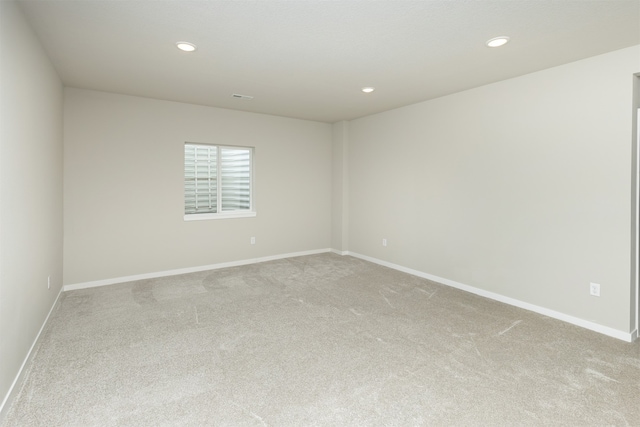 unfurnished room with light colored carpet