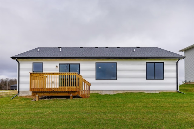 back of property featuring a lawn and a deck