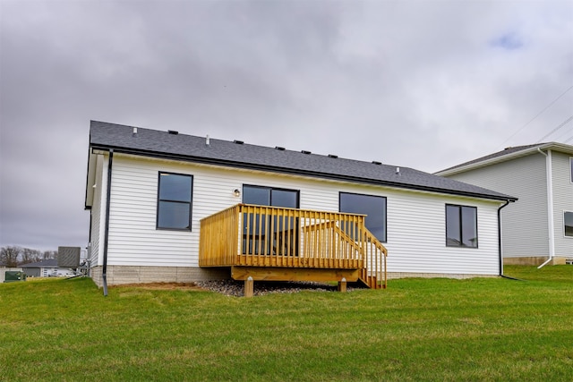 back of house featuring a lawn, a wooden deck, and central AC