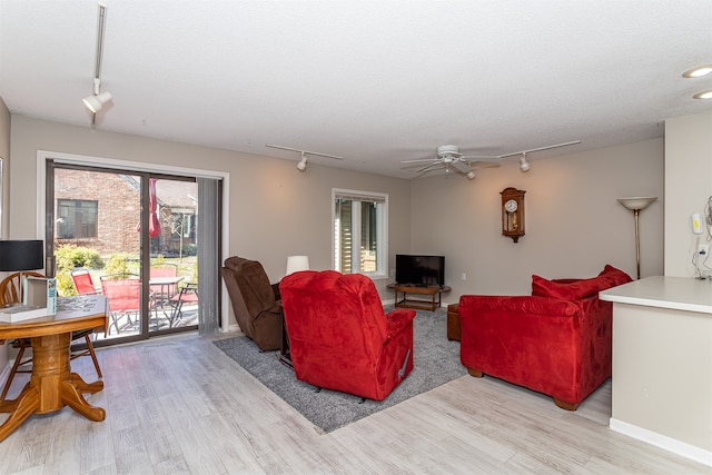 living room featuring light wood-type flooring, ceiling fan, and track lighting