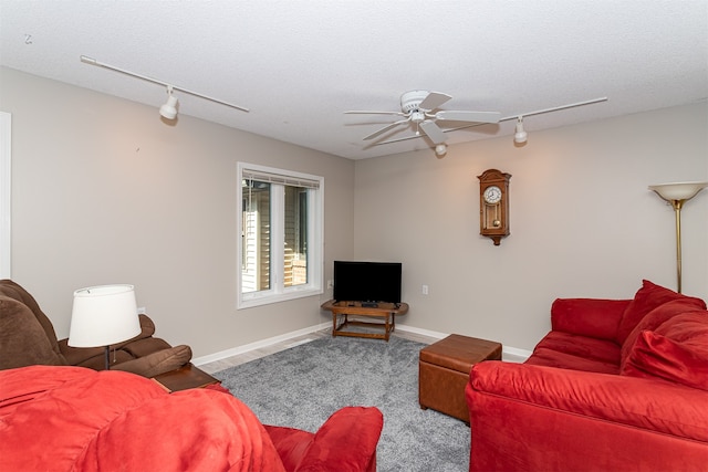 living room featuring ceiling fan, track lighting, carpet floors, and a textured ceiling