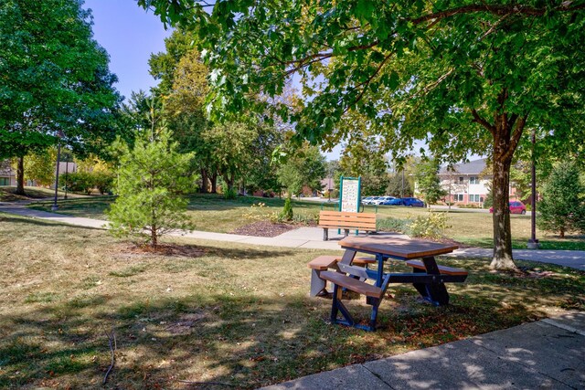 view of home's community with a yard