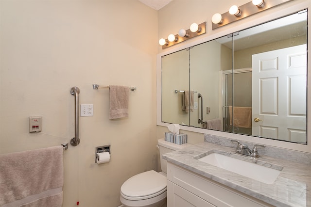 bathroom featuring walk in shower, vanity, and toilet