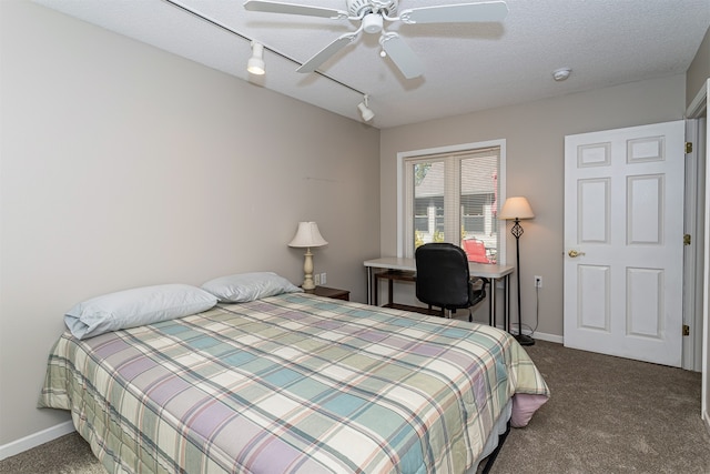 carpeted bedroom featuring ceiling fan and a textured ceiling