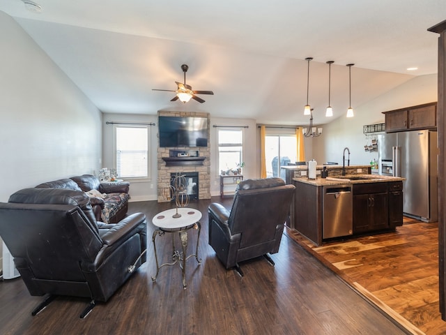 living room featuring a healthy amount of sunlight, dark hardwood / wood-style flooring, ceiling fan, and lofted ceiling