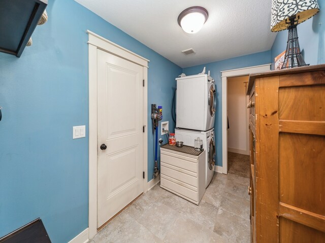 laundry room with stacked washer and clothes dryer