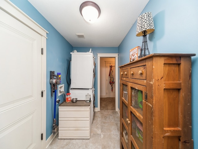 interior space featuring stacked washer and dryer