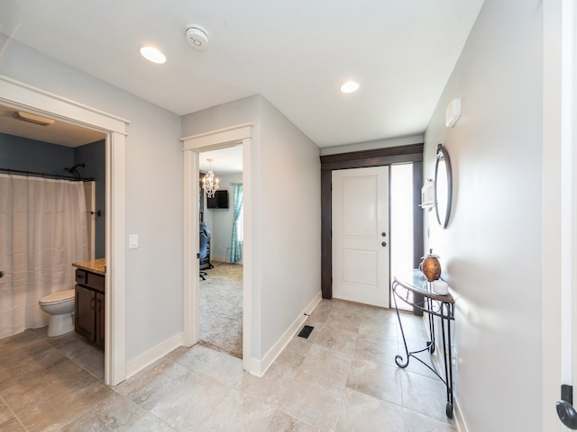 foyer entrance with an inviting chandelier