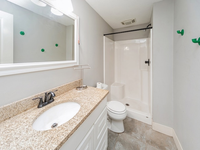 bathroom with a shower, vanity, and toilet