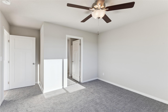 unfurnished bedroom featuring ceiling fan and carpet