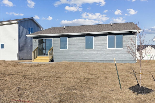 back of house featuring a yard