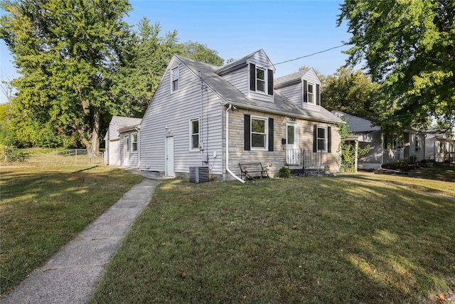 new england style home with central AC and a front yard