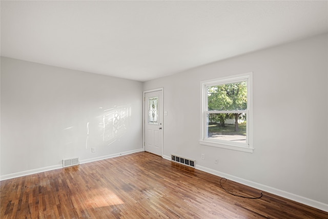 unfurnished room with hardwood / wood-style flooring