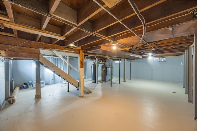 basement featuring heating unit and water heater