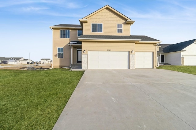 view of front of house with an attached garage, concrete driveway, and a front yard