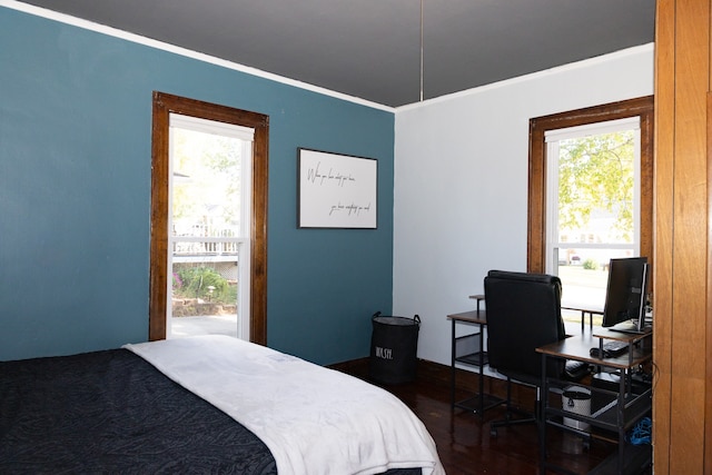 bedroom with dark hardwood / wood-style flooring and ornamental molding