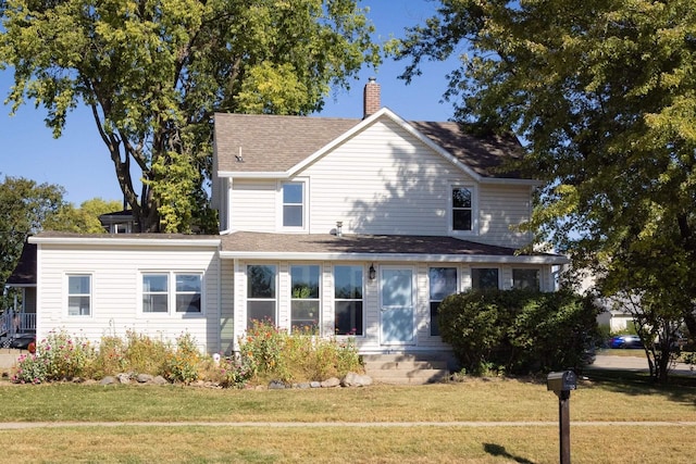 rear view of house with a yard