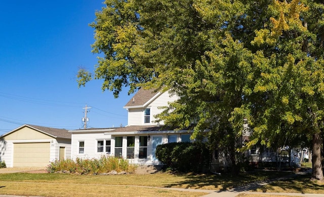 view of front of home with a garage and a front lawn