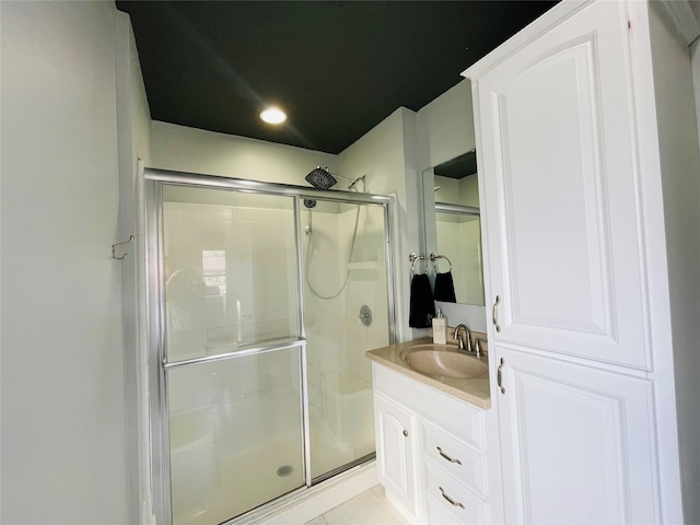 bathroom with tile patterned floors, vanity, and an enclosed shower