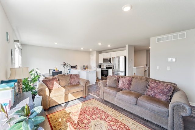 living room featuring a fireplace and hardwood / wood-style flooring