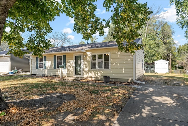 ranch-style home with a storage unit