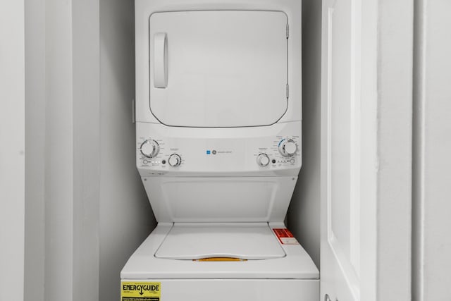 washroom with stacked washer and dryer