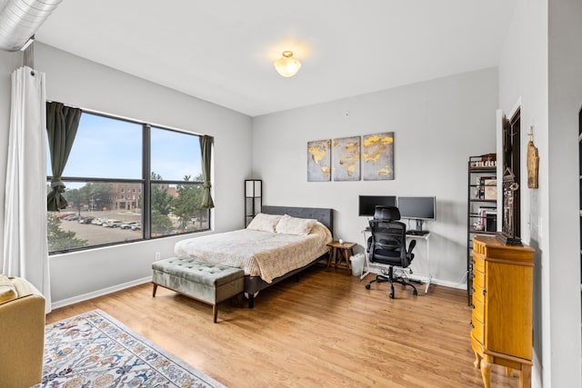 bedroom with hardwood / wood-style flooring