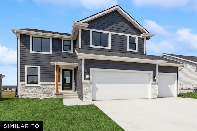 view of front of property with a garage and a front lawn