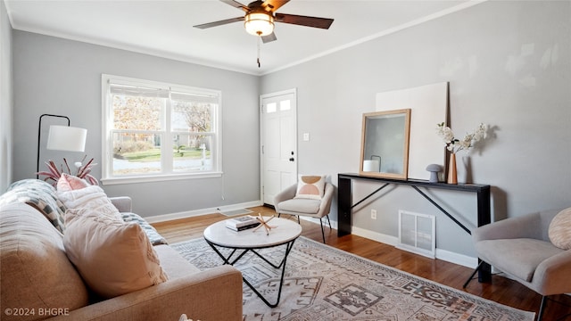 living room featuring ceiling fan, wood-type flooring, and ornamental molding