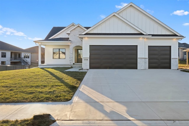 view of front of home with a front lawn and a garage