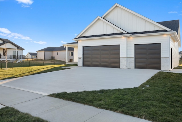 view of front facade with a front yard, an outbuilding, and a garage