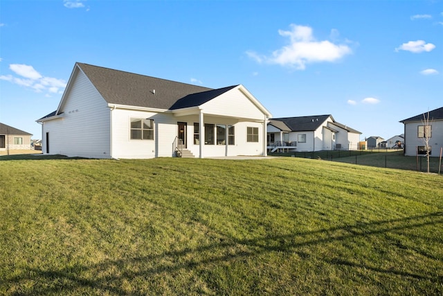 back of house with a lawn