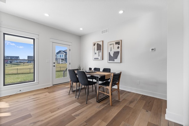 dining space with light hardwood / wood-style floors