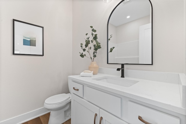 bathroom with a shower, vanity, wood-type flooring, and toilet