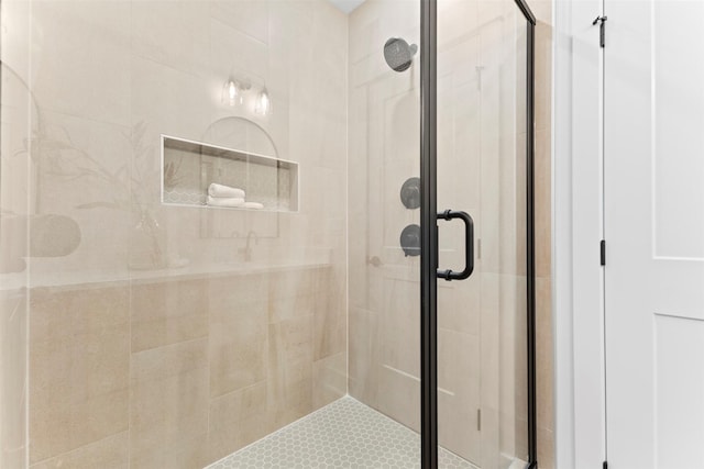 bathroom with a shower with door