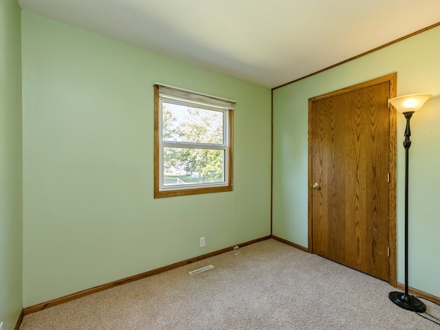 unfurnished bedroom featuring light carpet