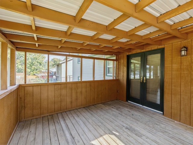 unfurnished sunroom featuring french doors and beam ceiling