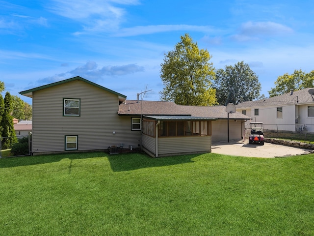 back of house featuring a lawn and a patio