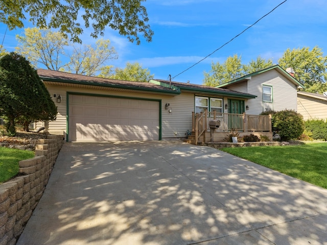 view of front of property with a garage, a front lawn, and covered porch