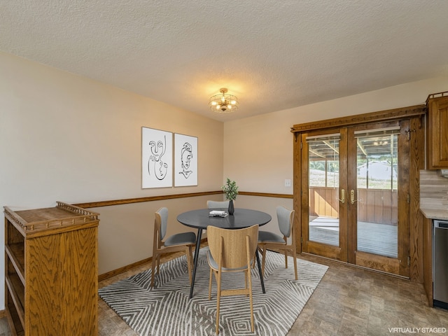 dining room with french doors and a textured ceiling