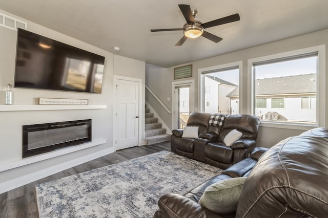 living room featuring dark hardwood / wood-style floors and ceiling fan