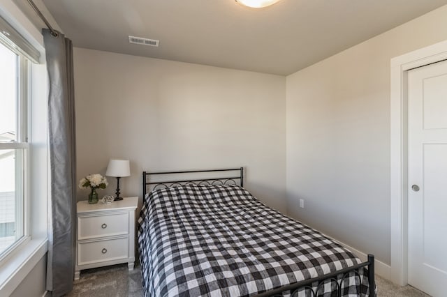 bedroom with dark carpet