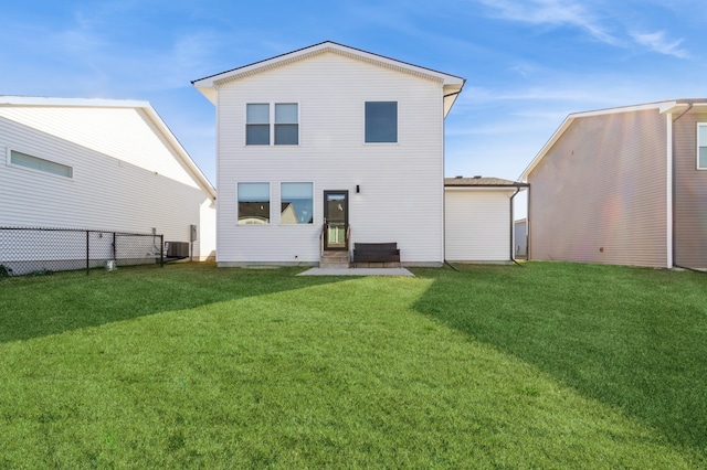 back of property featuring a yard and central AC unit