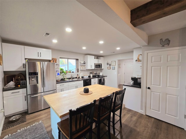 kitchen featuring visible vents, dark wood-style floors, appliances with stainless steel finishes, white cabinetry, and open shelves