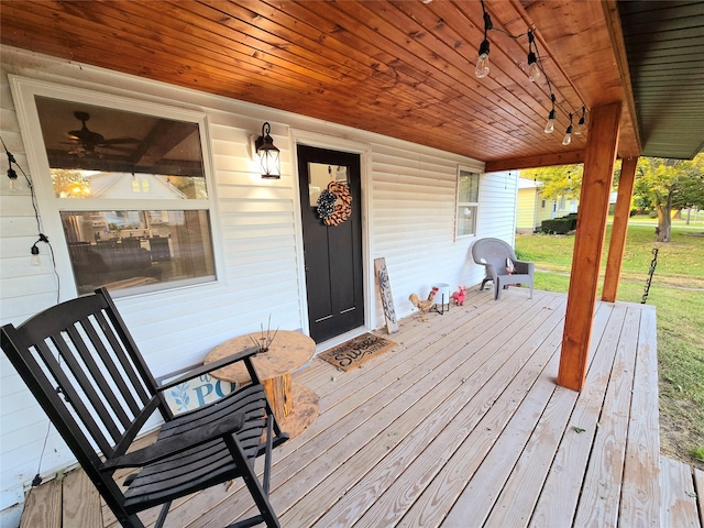 wooden terrace featuring a yard