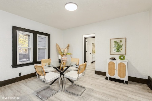 dining space featuring light hardwood / wood-style floors